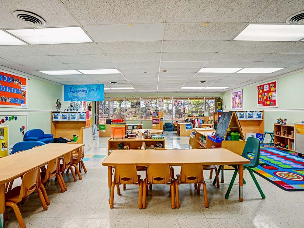 Empty classroom with small tables and chairs
