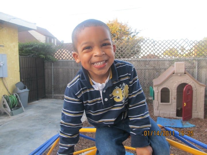 Child smiling on a playground structure