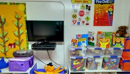 TV and storage bins with toys in a classroom