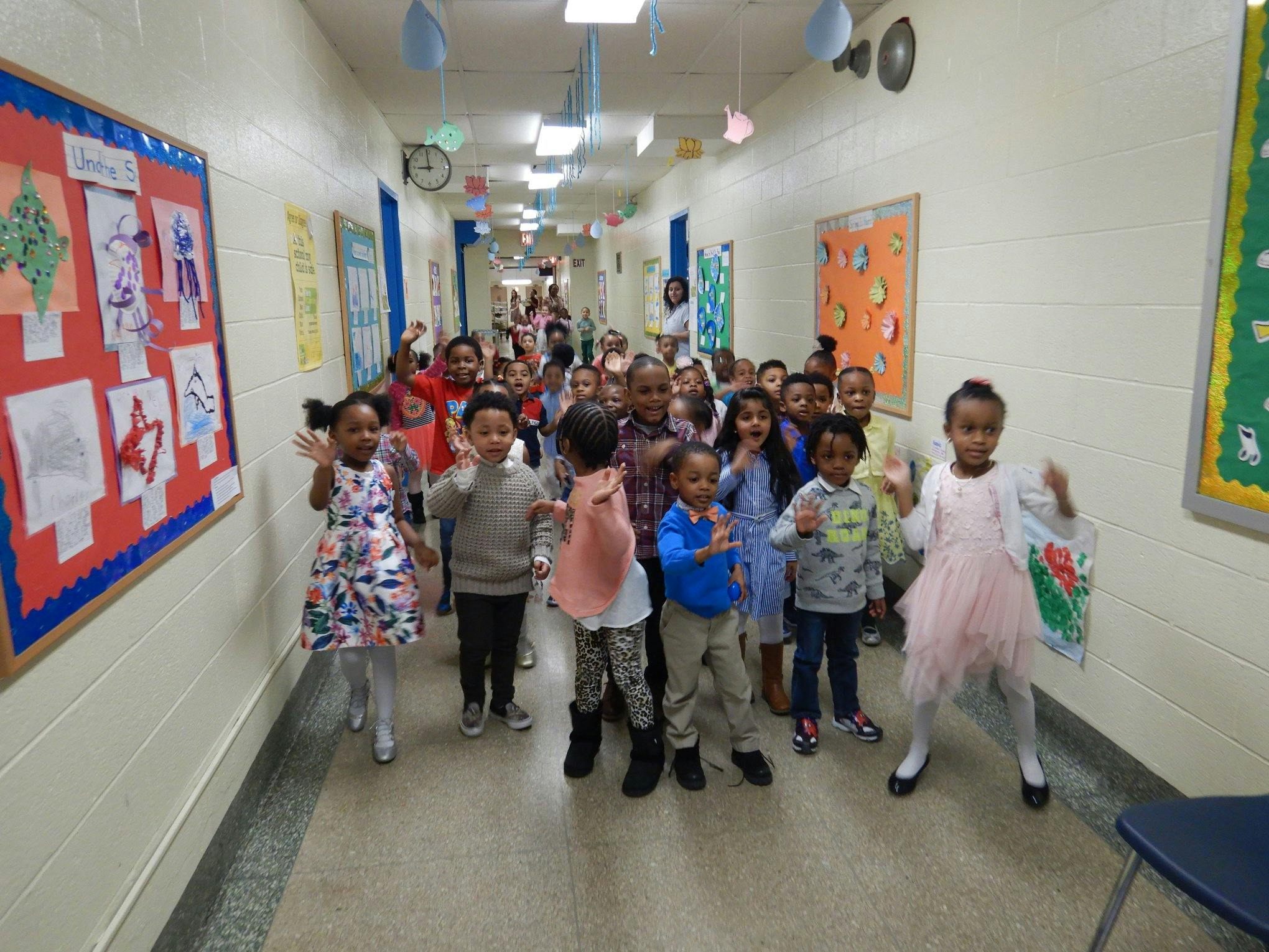 Group of children walking down a school hallway