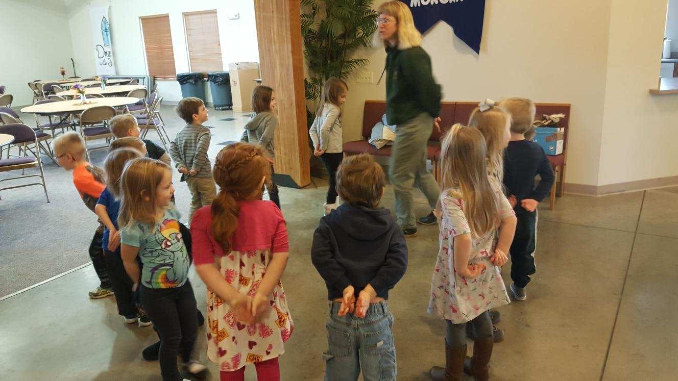 Adult and children standing in a line