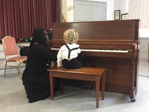 Person and child at a piano