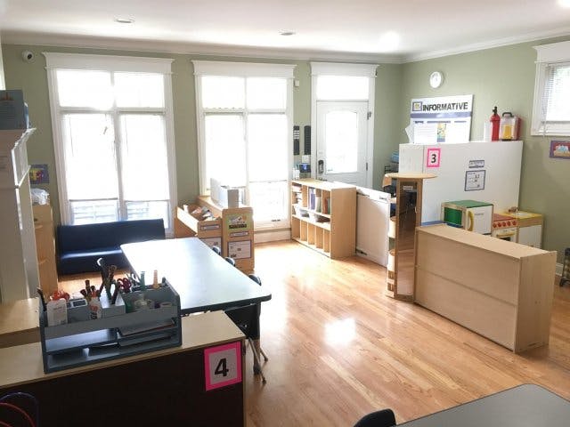 Classroom with tables, chairs, and storage units