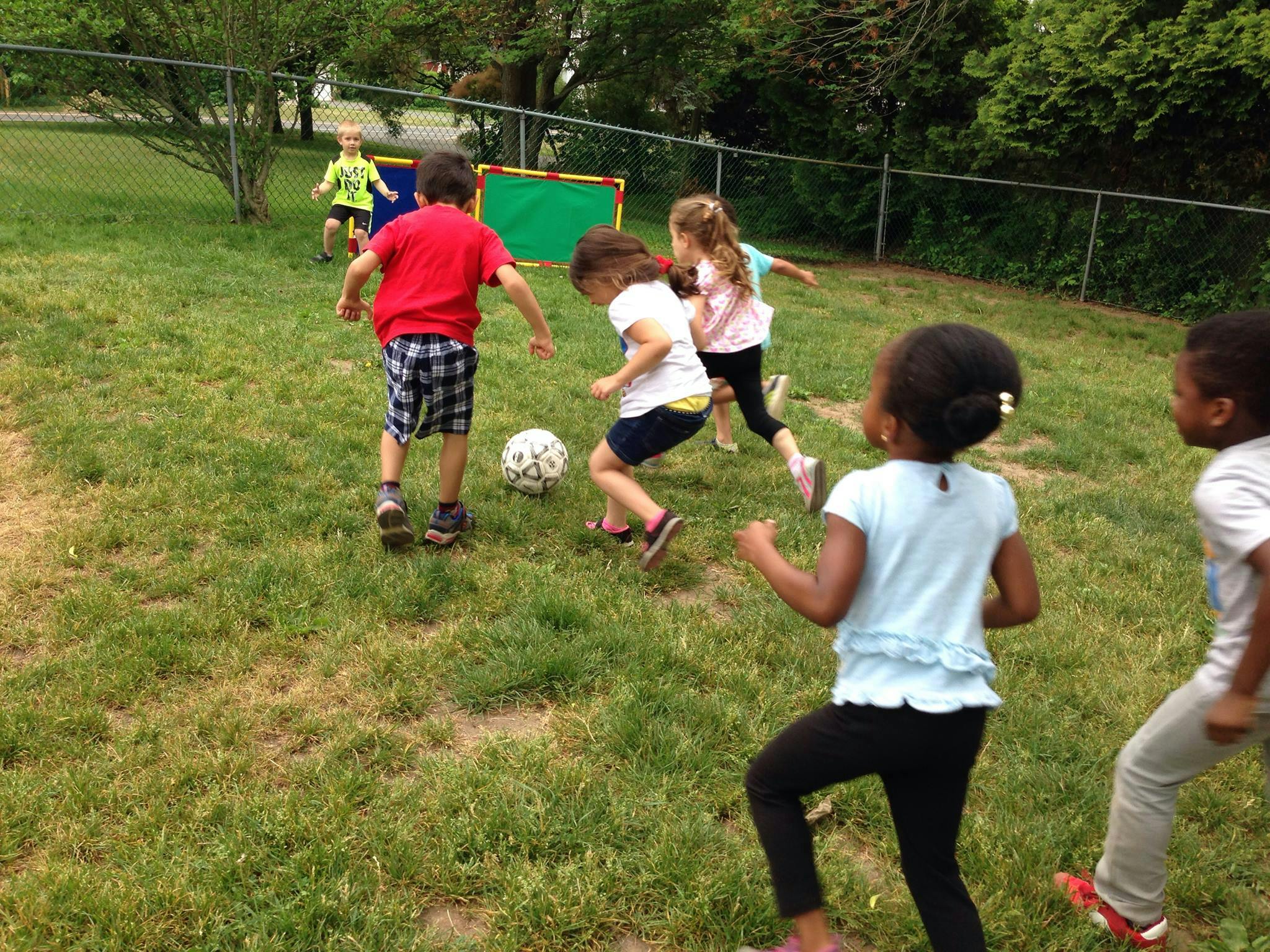 Children playing soccer outdoors