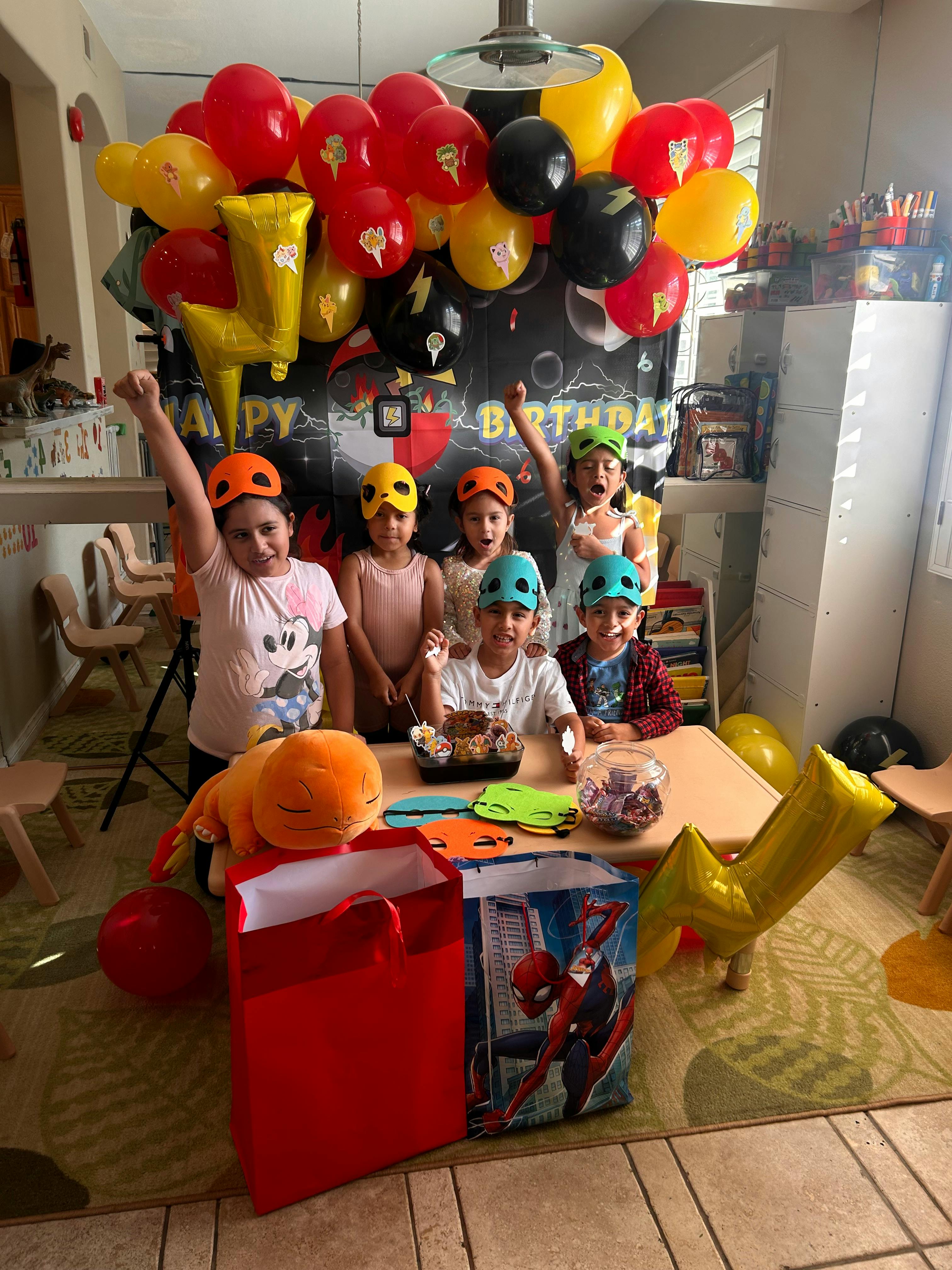 Children wearing masks and helmets at a birthday party