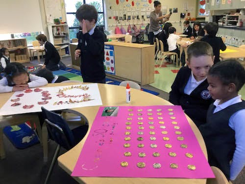 Children in a classroom working on art projects at tables