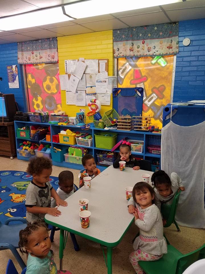 Children sitting around a table in a classroom