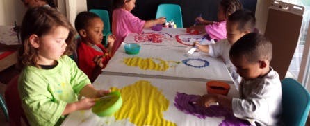 Children painting at a table