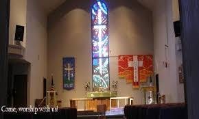 Church interior with stained glass window and altar