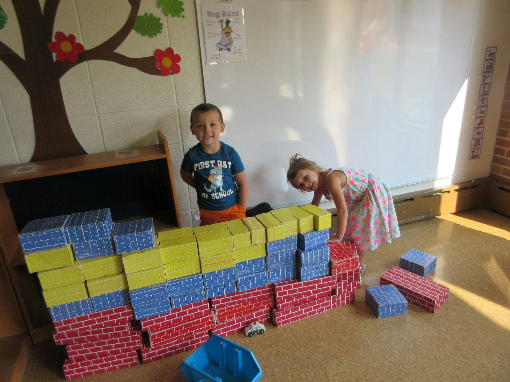 Two children playing with building blocks