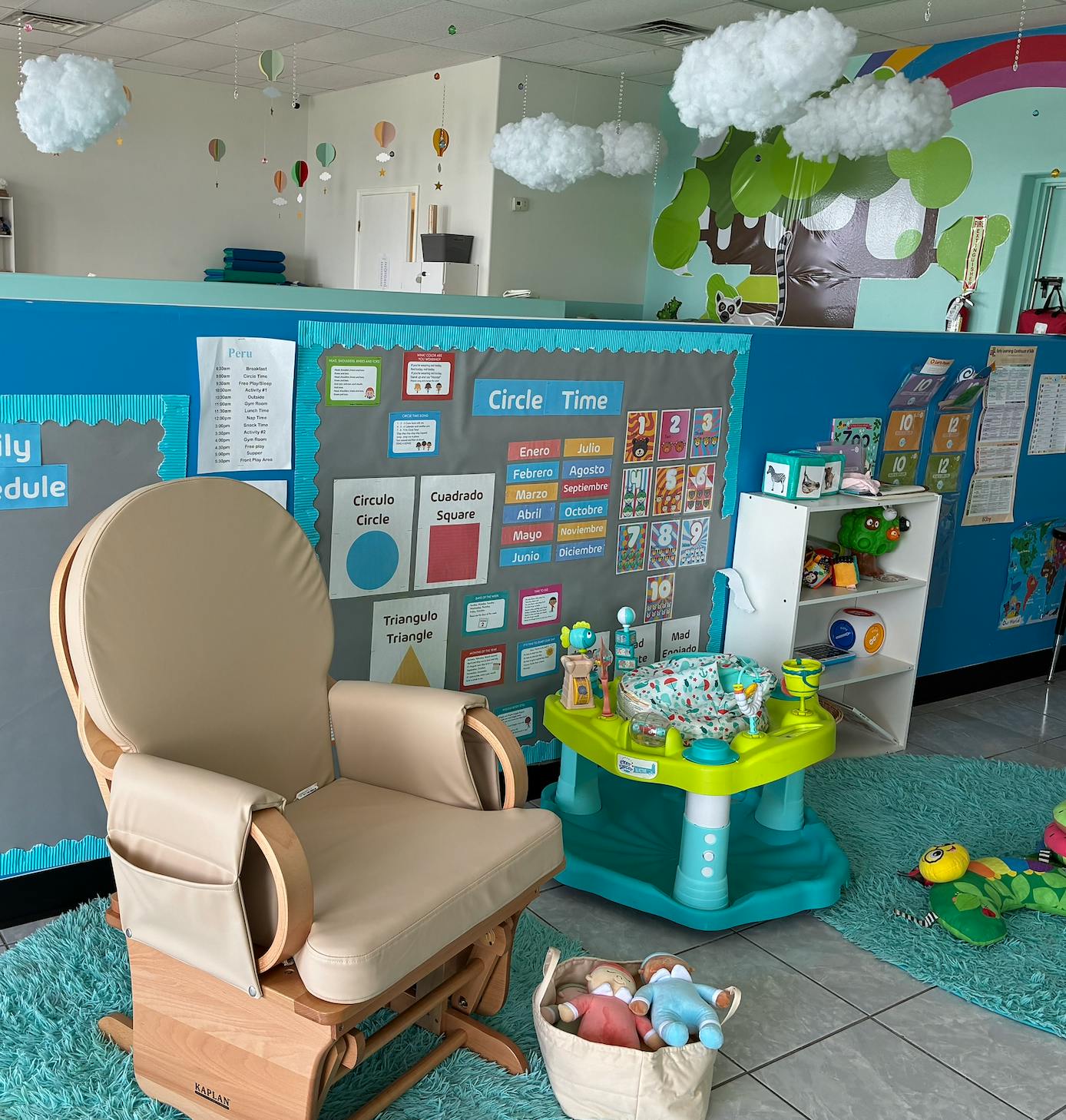 Rocking chair and baby activity center in a classroom with a "Circle Time" board