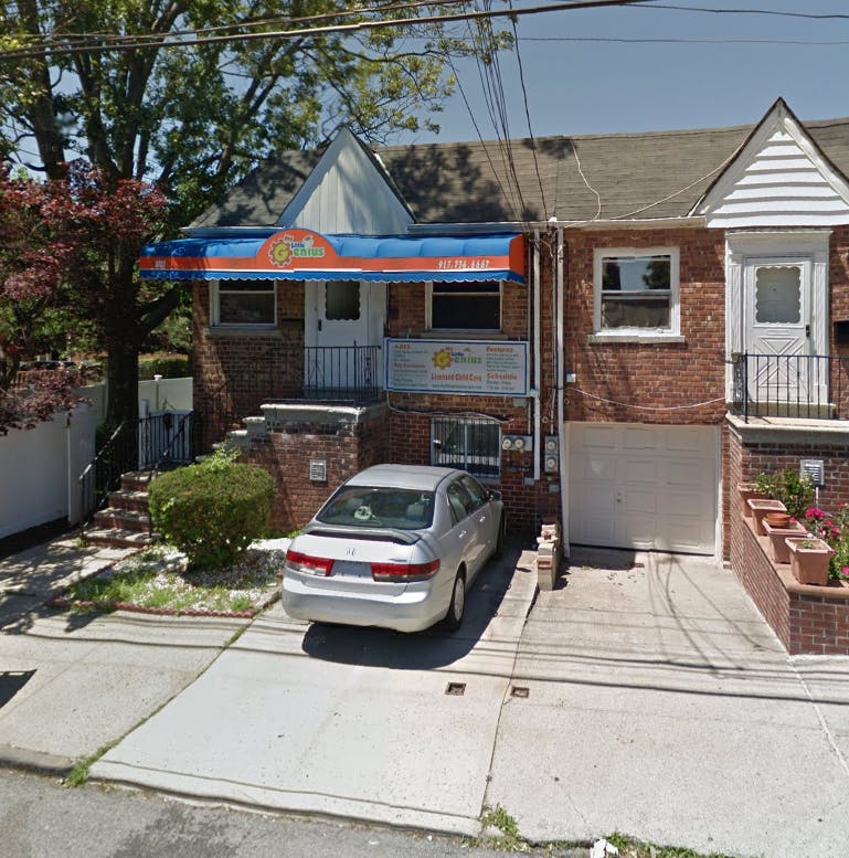 Brick house with a blue and orange awning over the entrance