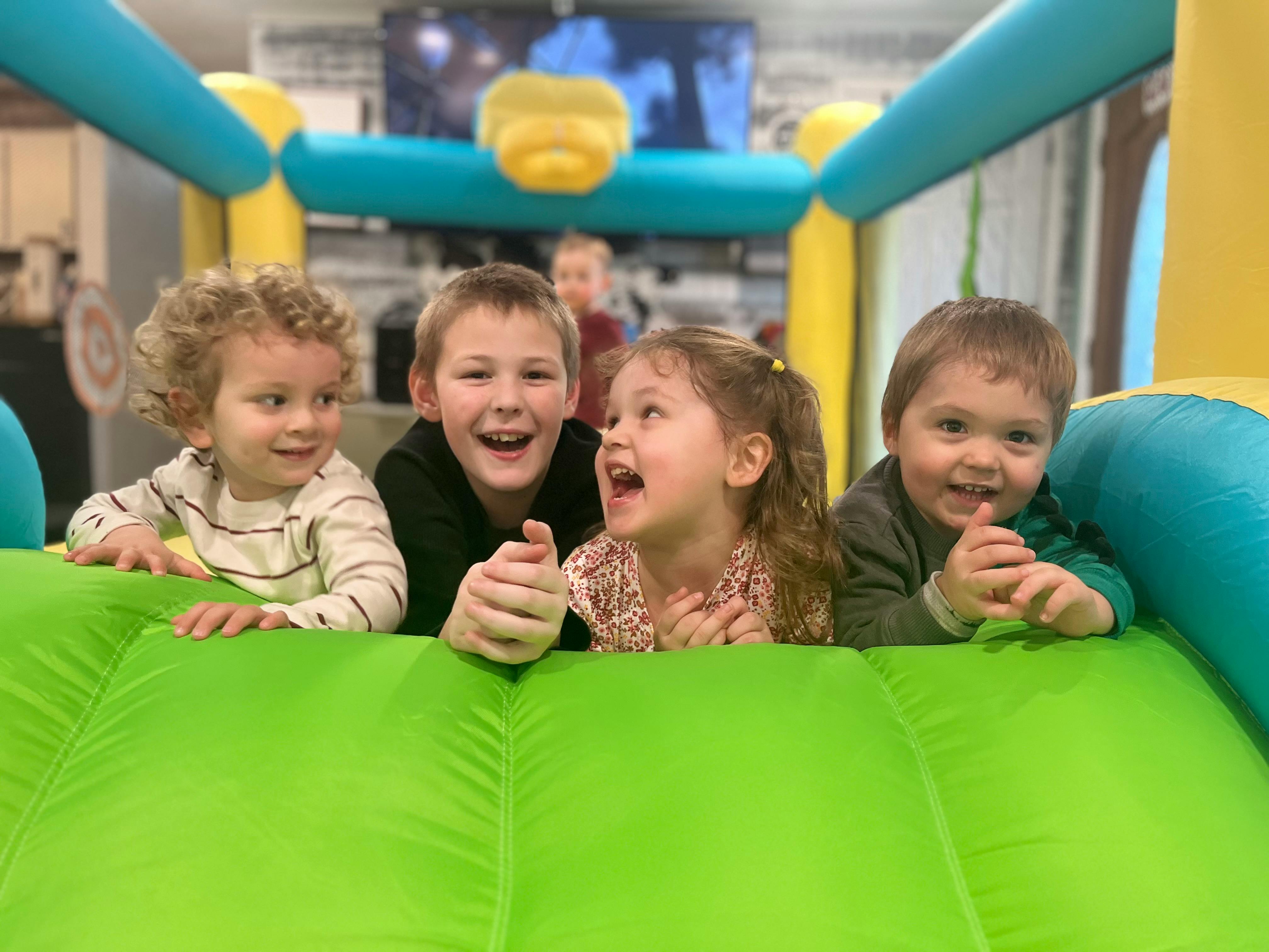 Four children in an inflatable play structure