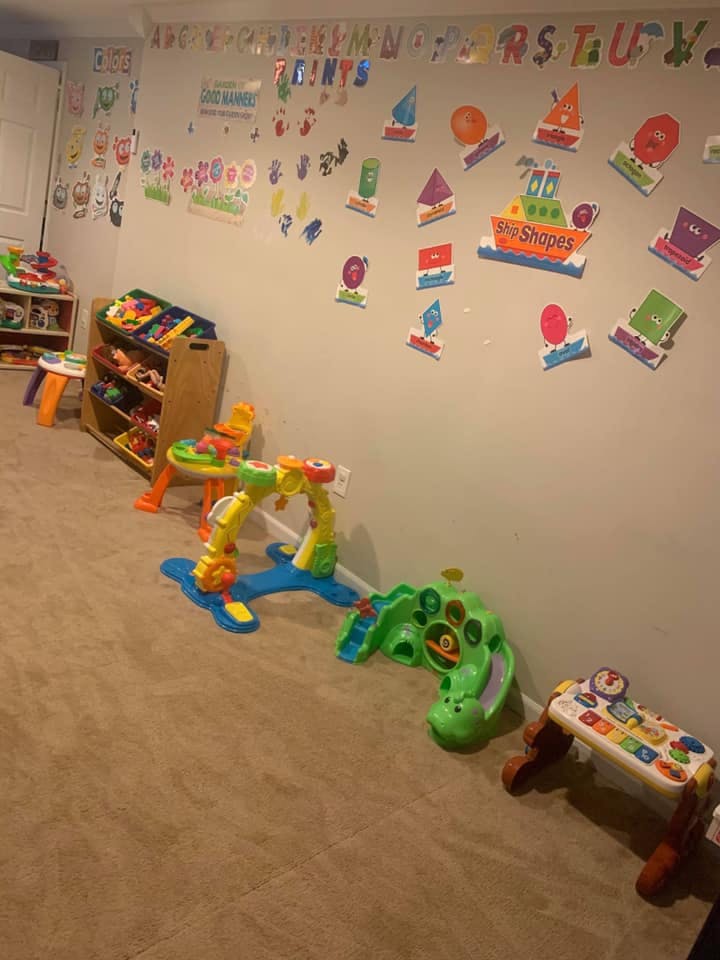 Playroom with toys and alphabet and shape cutouts on the wall
