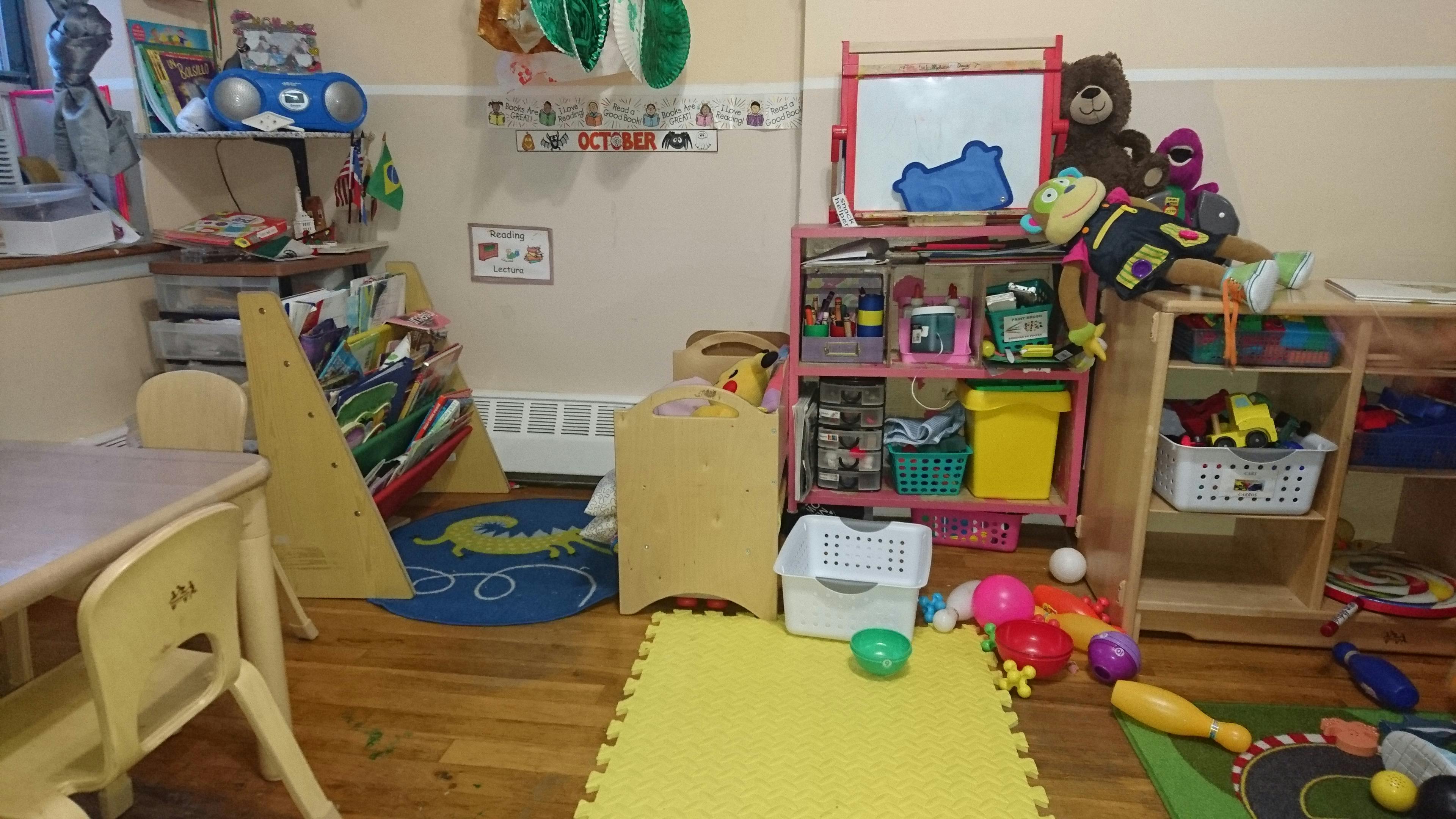 Playroom with toys, shelves, small table and chairs