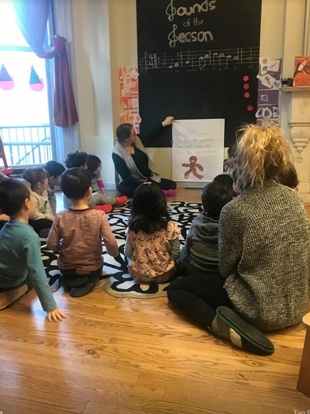 Adult teaching children in a classroom
