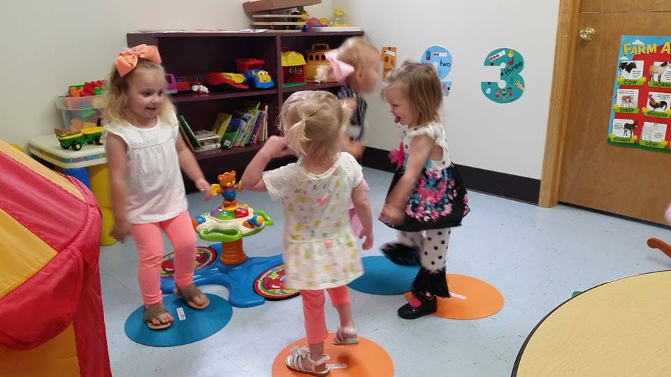 Three children playing in a room
