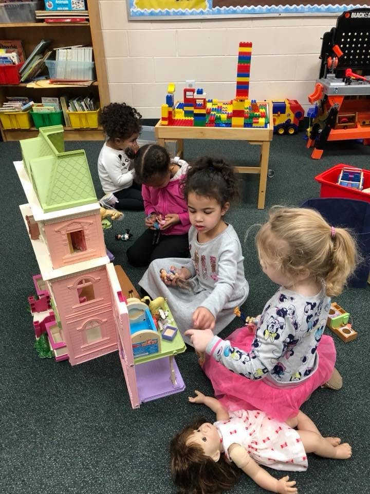 Children playing with toys on the floor