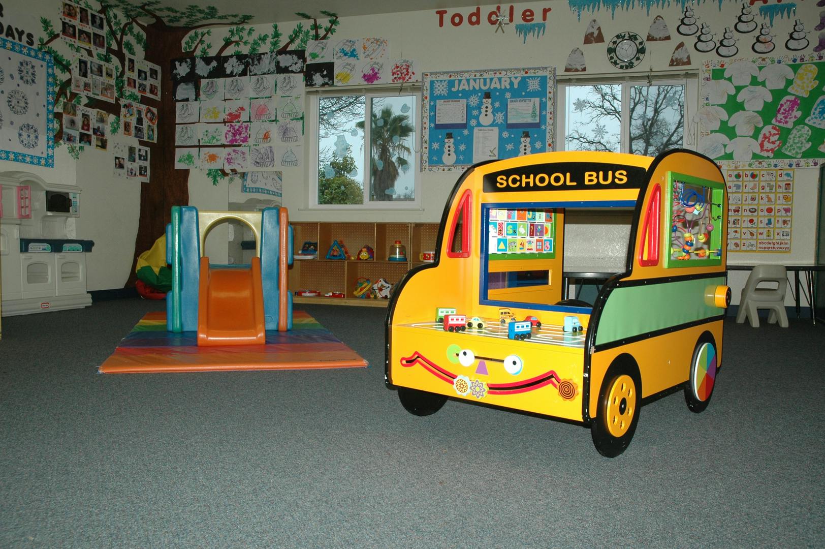 Play school bus and play structure in a classroom