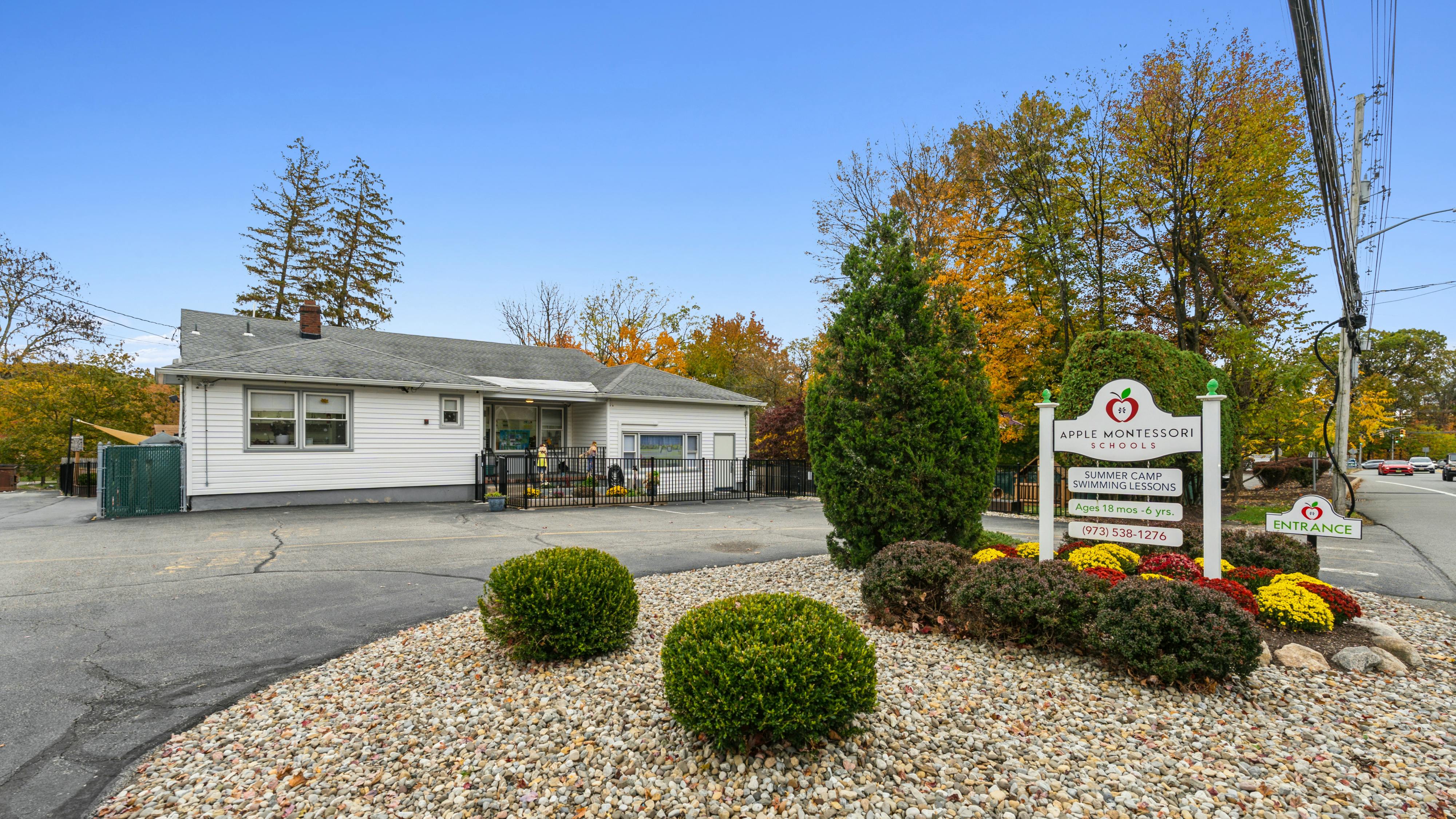 Apple Montessori Schools sign and building exterior in autumn