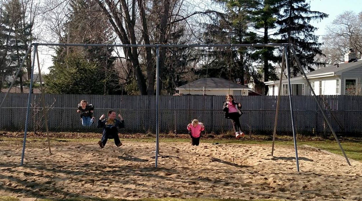Children playing on a swing set