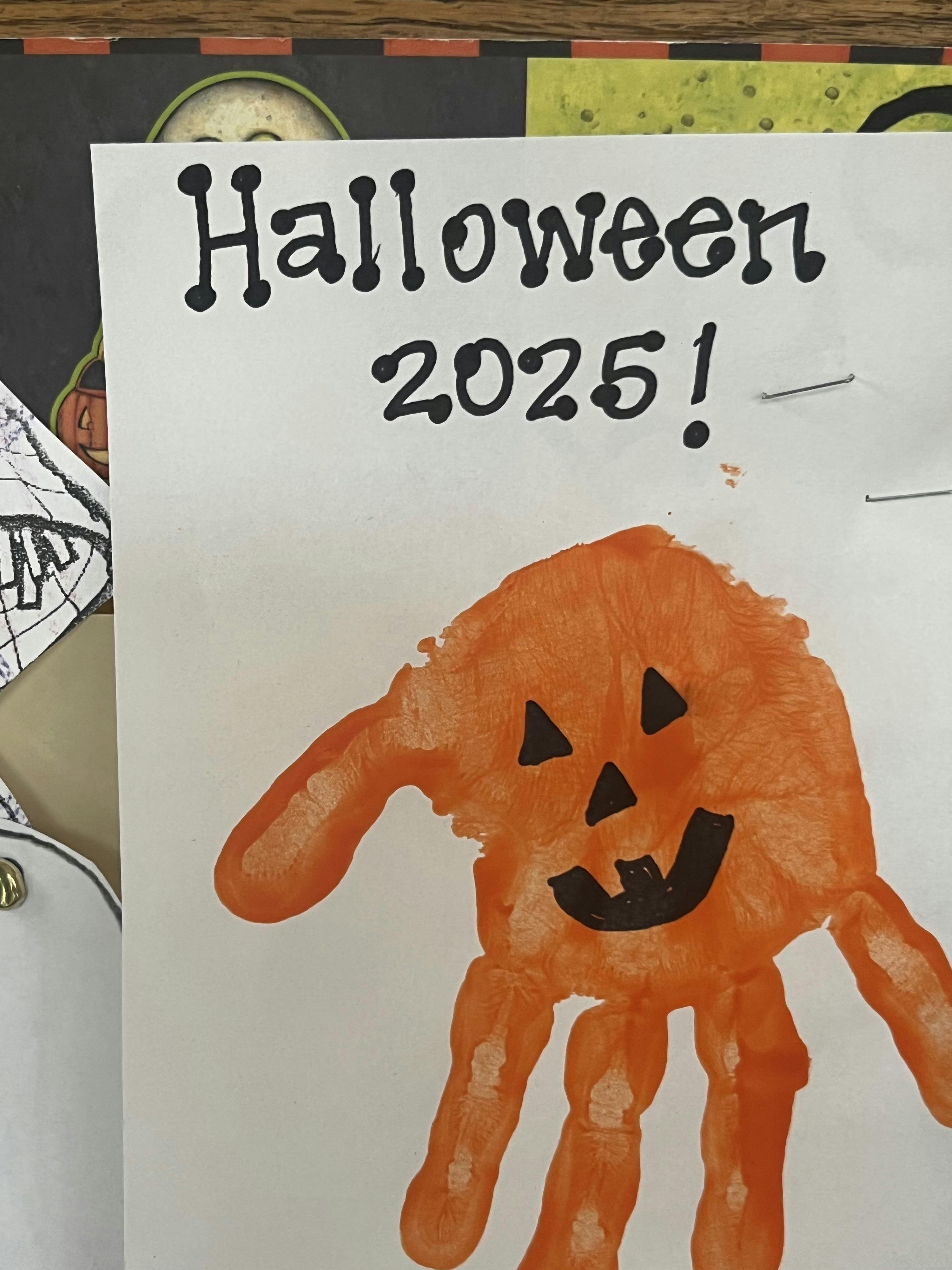 Child's orange handprint jack-o-lantern craft labeled Halloween 2025