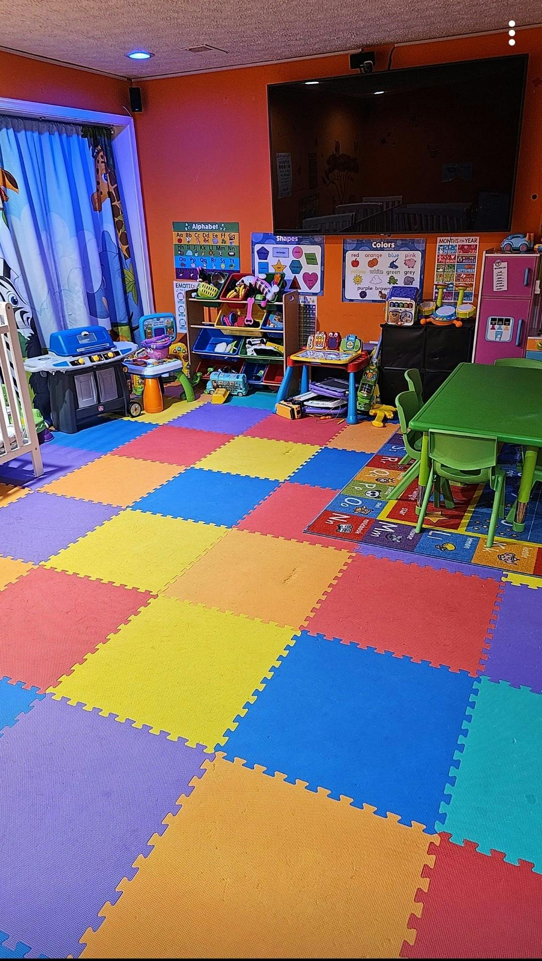 Playroom with colorful interlocking floor mats and various toys