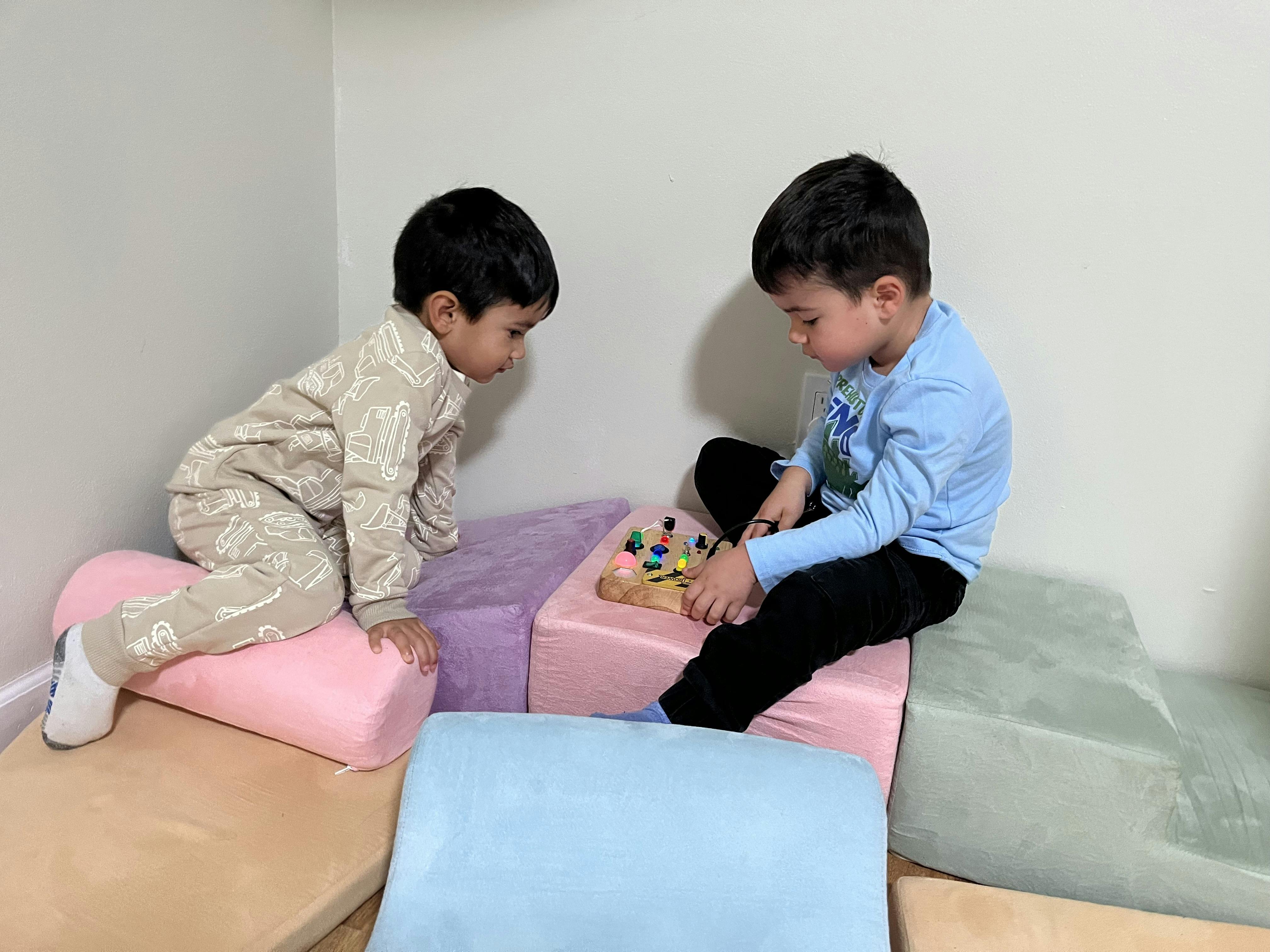 Two children playing with soft blocks