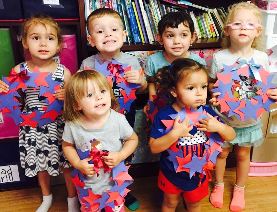 Group of children holding star-shaped paper crafts