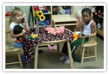 Two children sitting at a small table