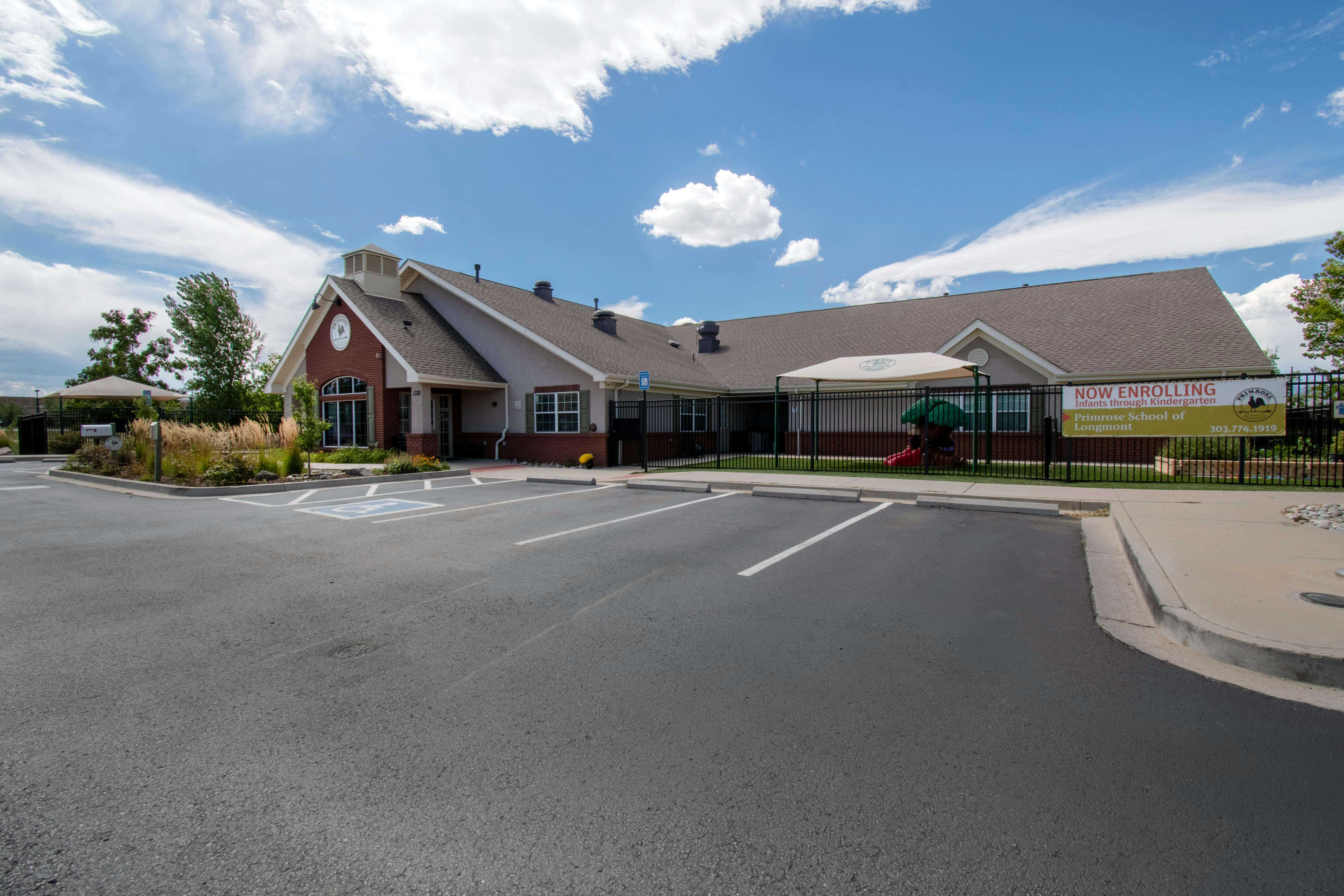 Exterior view of Primrose School of Longmont, a building with a playground and parking lot