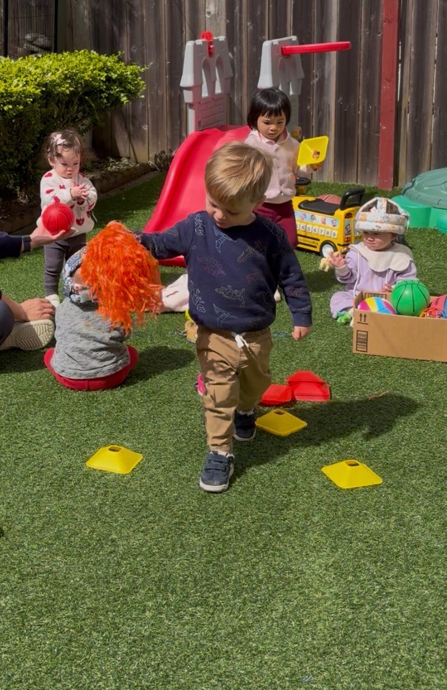 Group of children playing with toys on artificial turf