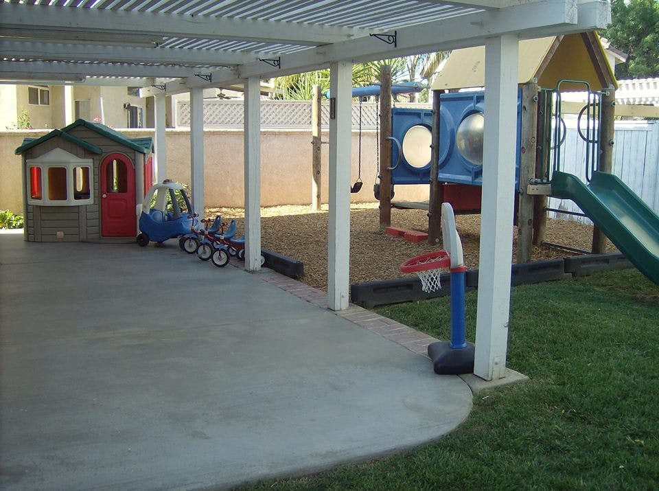Playground with playhouse, toy car, and slide