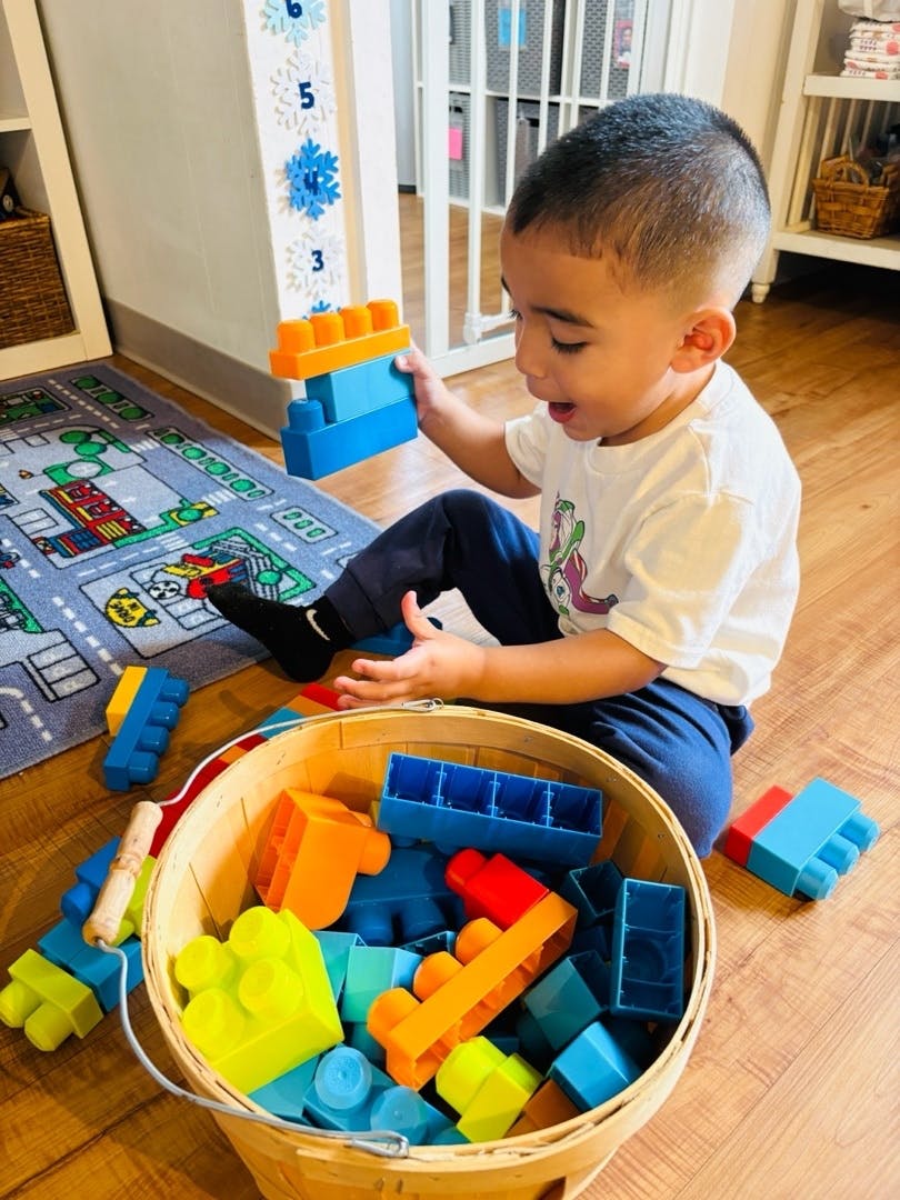 Child playing with building blocks on the floor