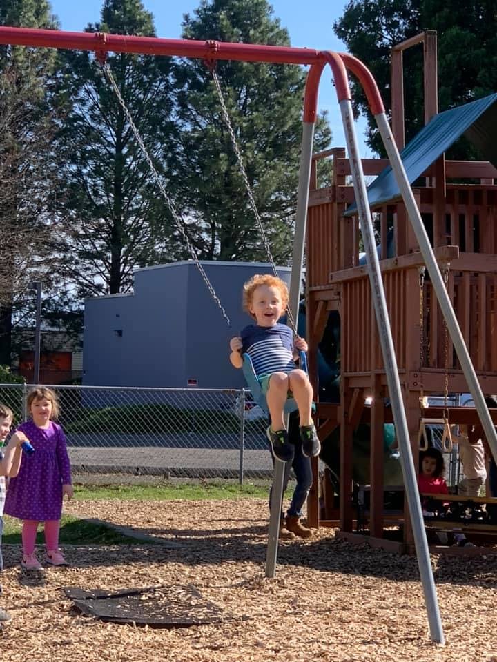 Child on a swing at a playground