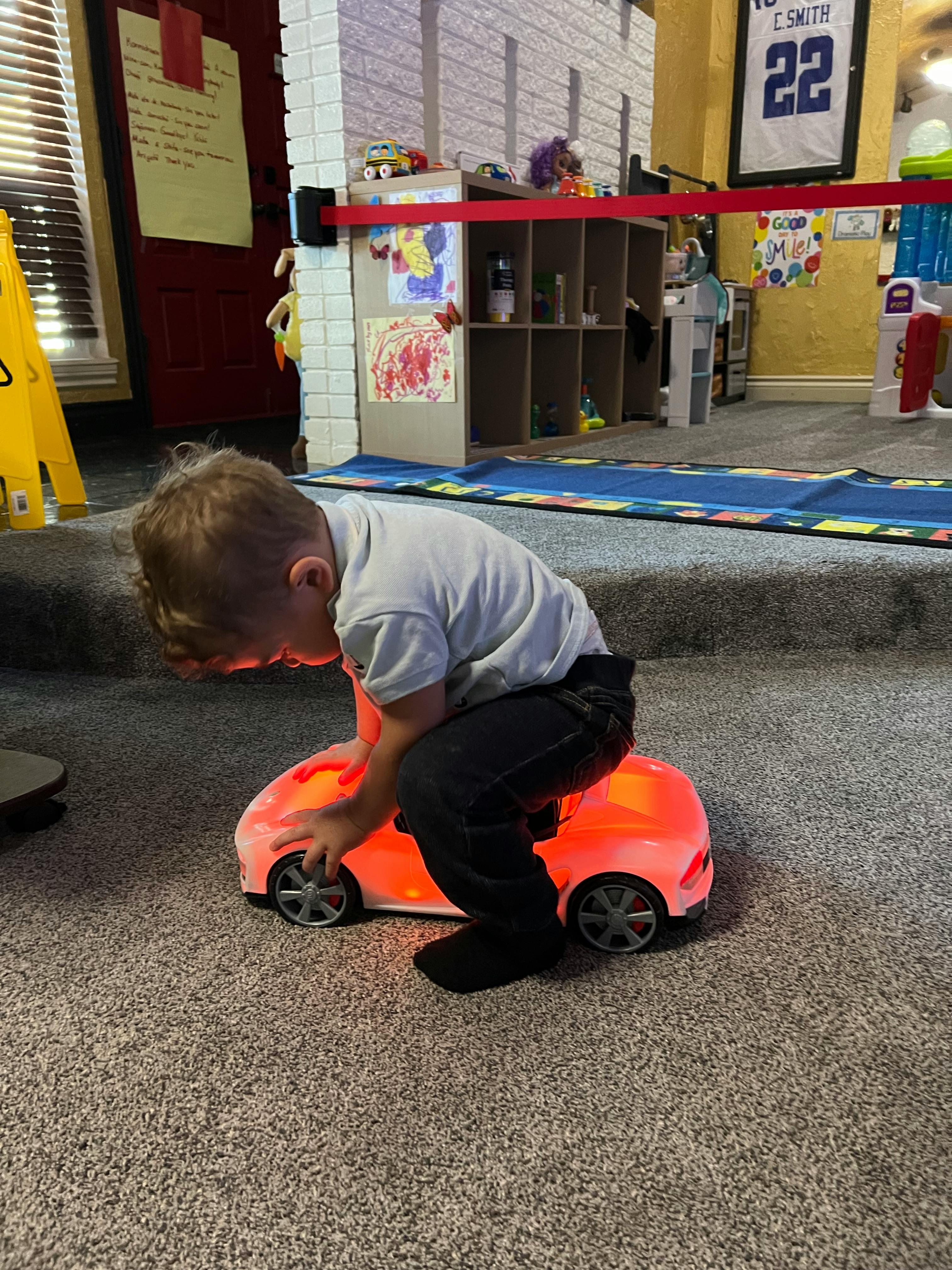 Child playing with a glowing toy car