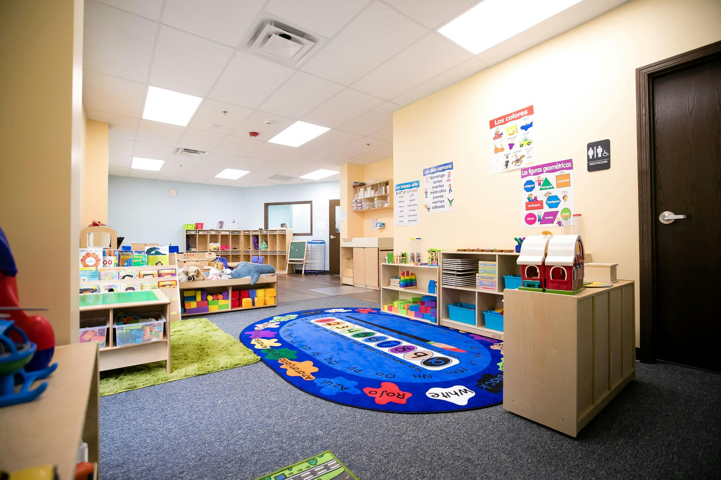 Classroom with colorful rugs and shelves