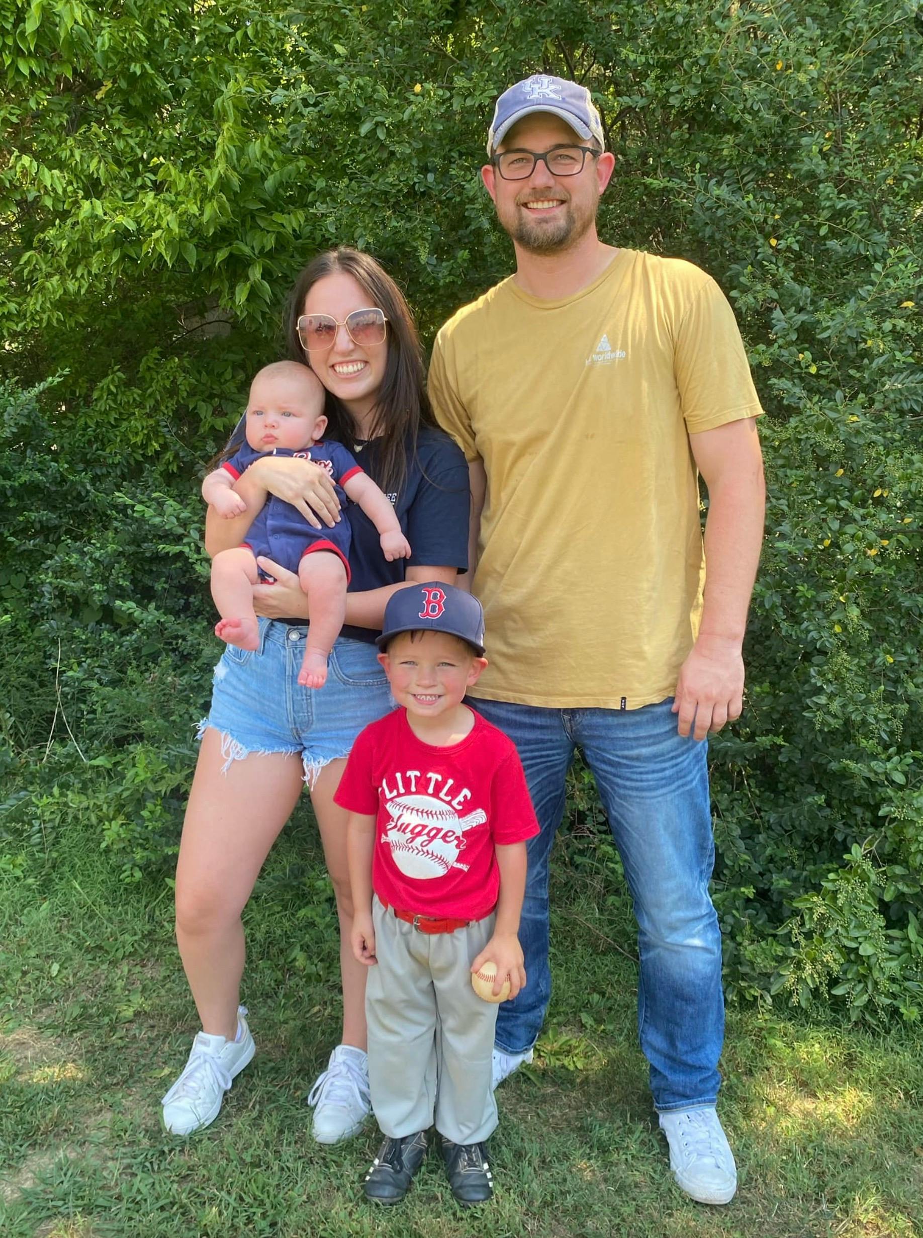 Two adults and two children posing outdoors