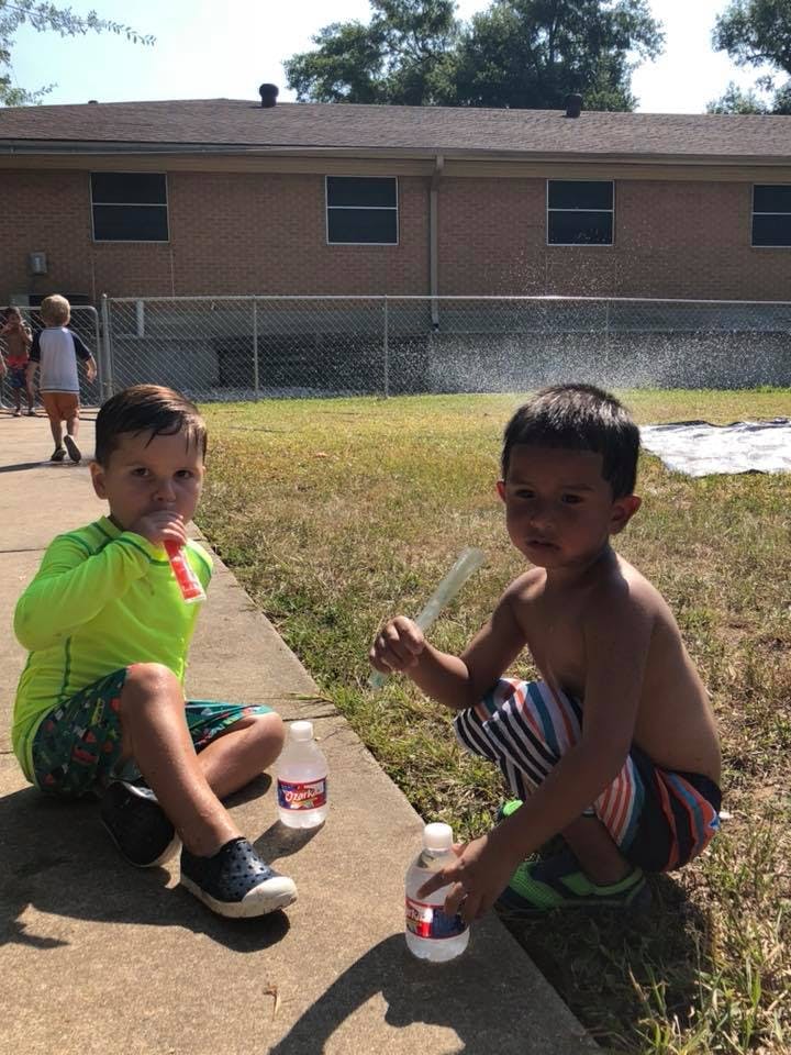 Two children playing with bubbles outdoors