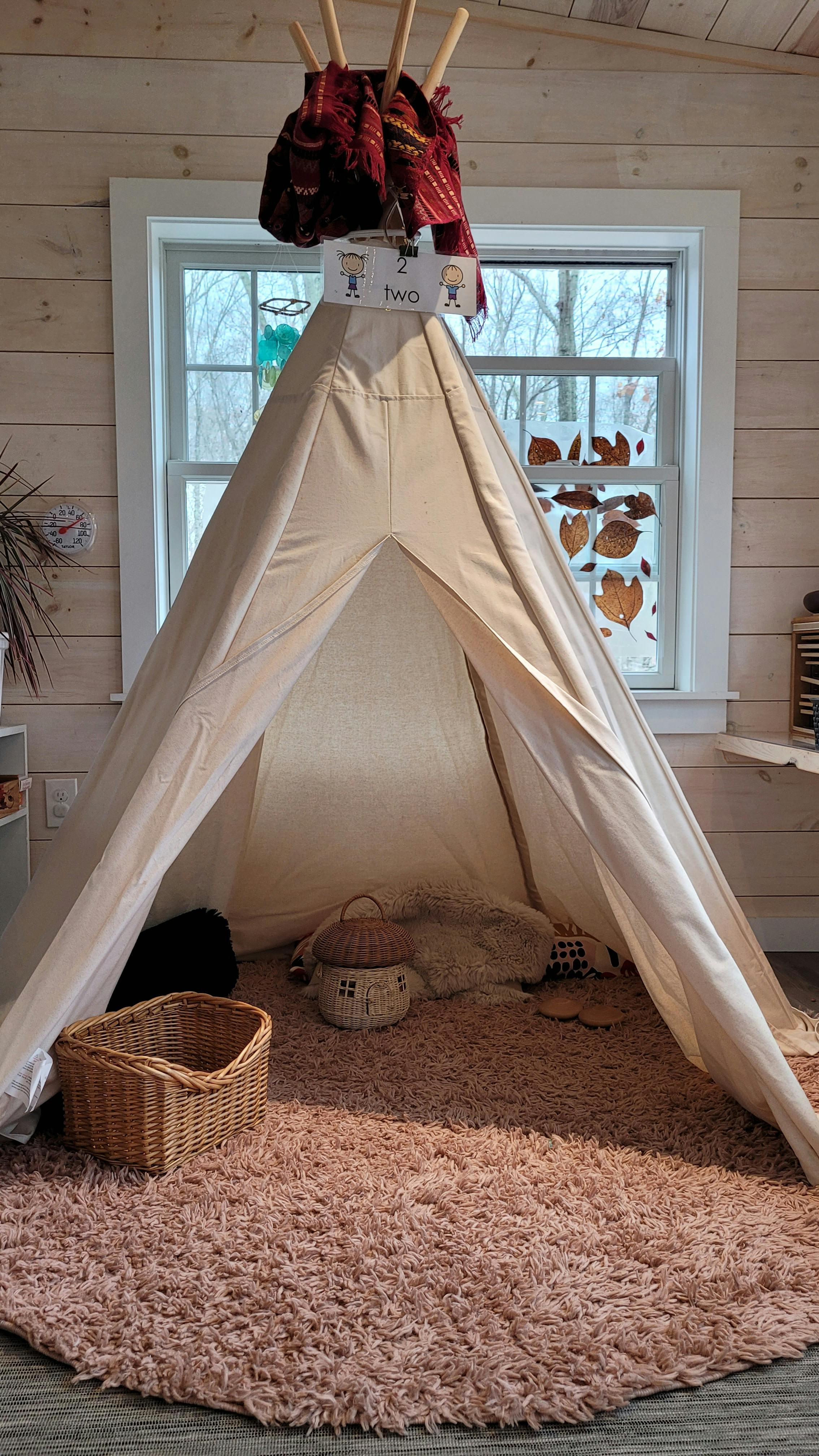 Play tent with a fluffy rug and baskets