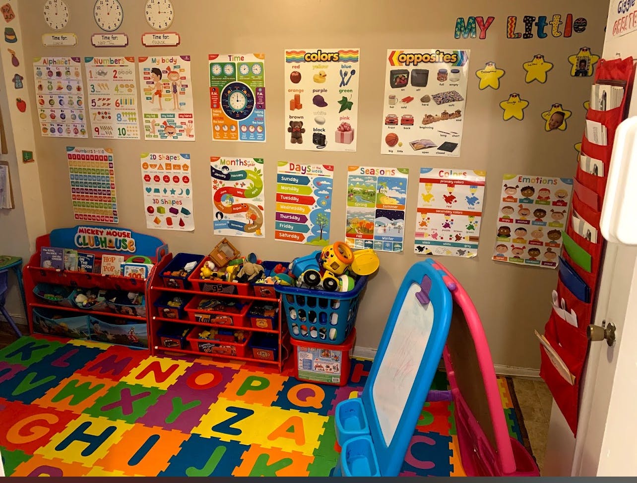 Child's playroom with alphabet mat, toy shelves, and educational posters