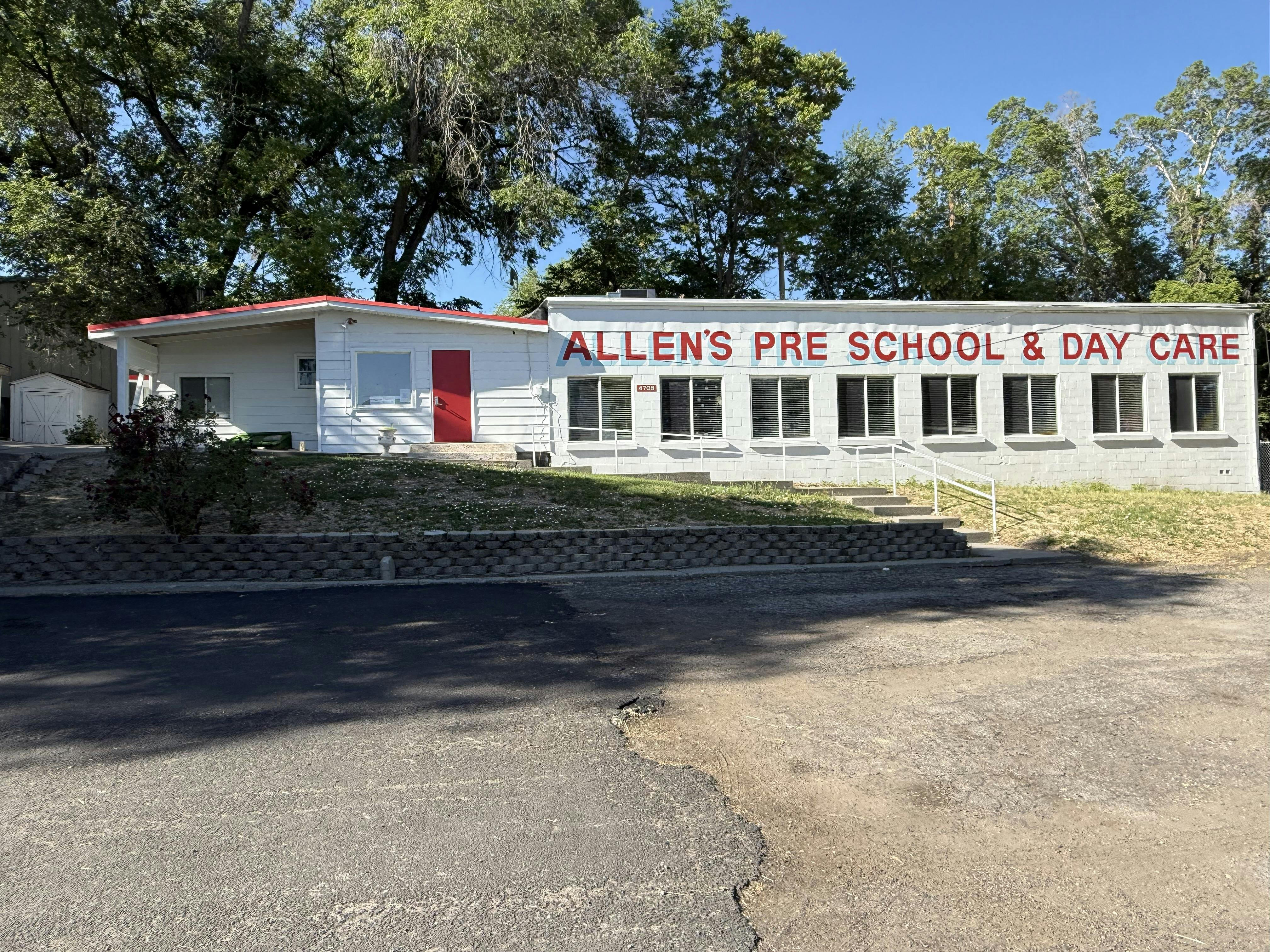 White building with red trim and "Allen's Pre School & Day Care" sign