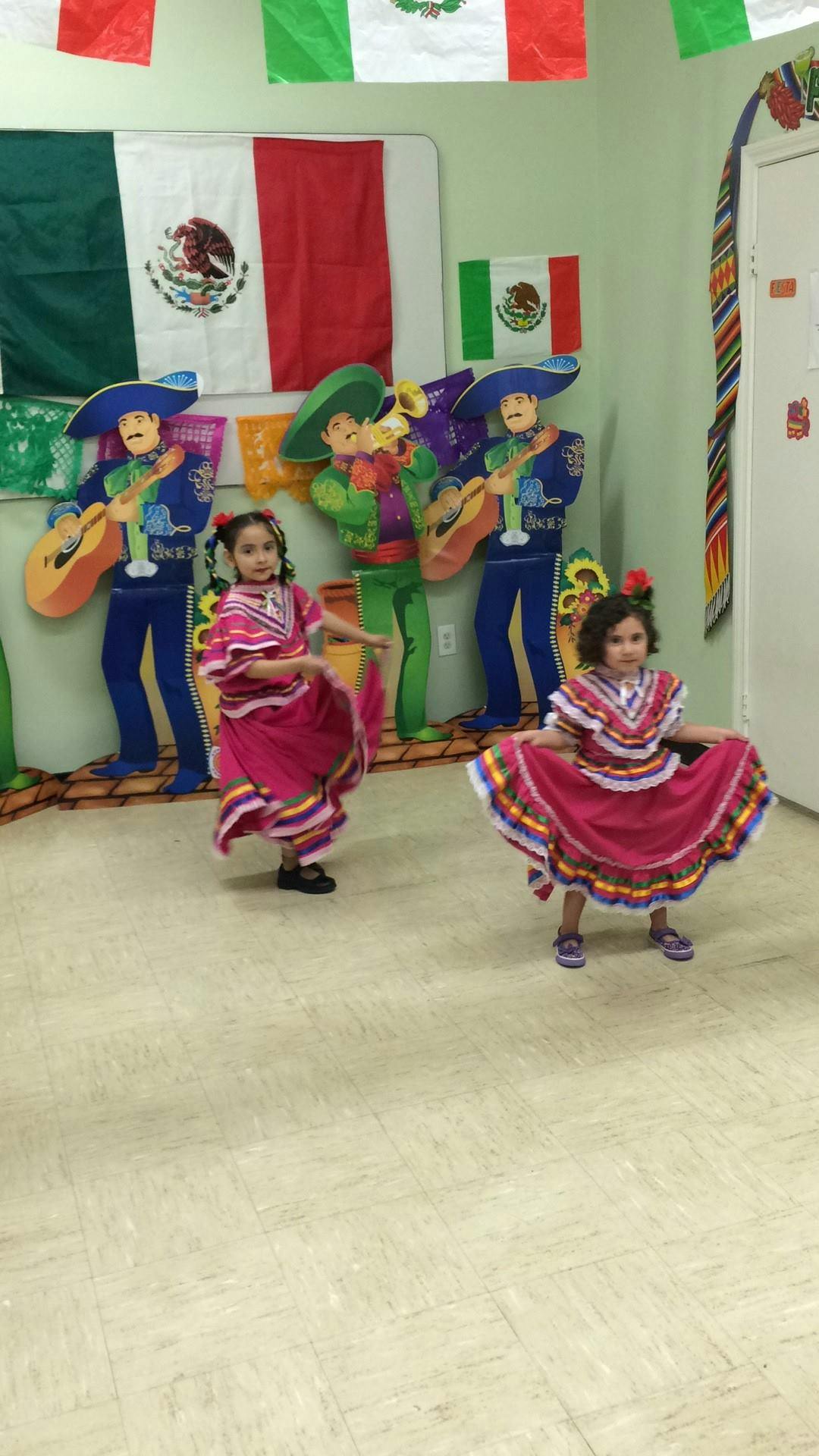 Two children in traditional dresses dancing