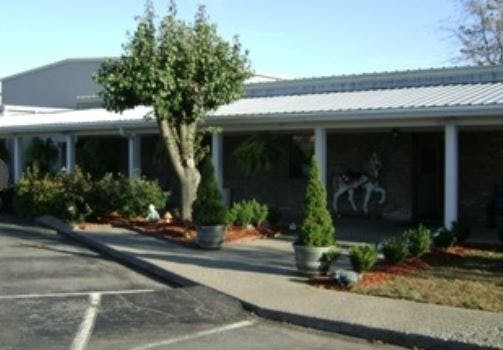 Building with a covered walkway and landscaping
