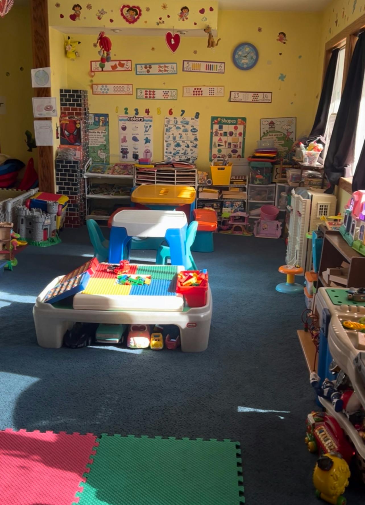 Playroom with a building block table and various toys
