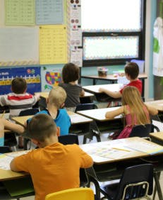 Children sitting at desks in a classroom