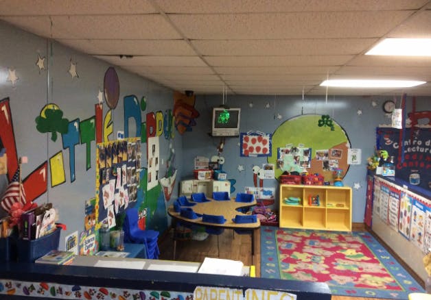 Classroom with small tables and chairs, colorful decorations on walls
