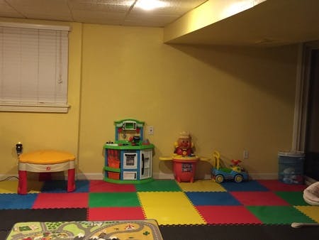 Playroom with colorful floor mats and various toys