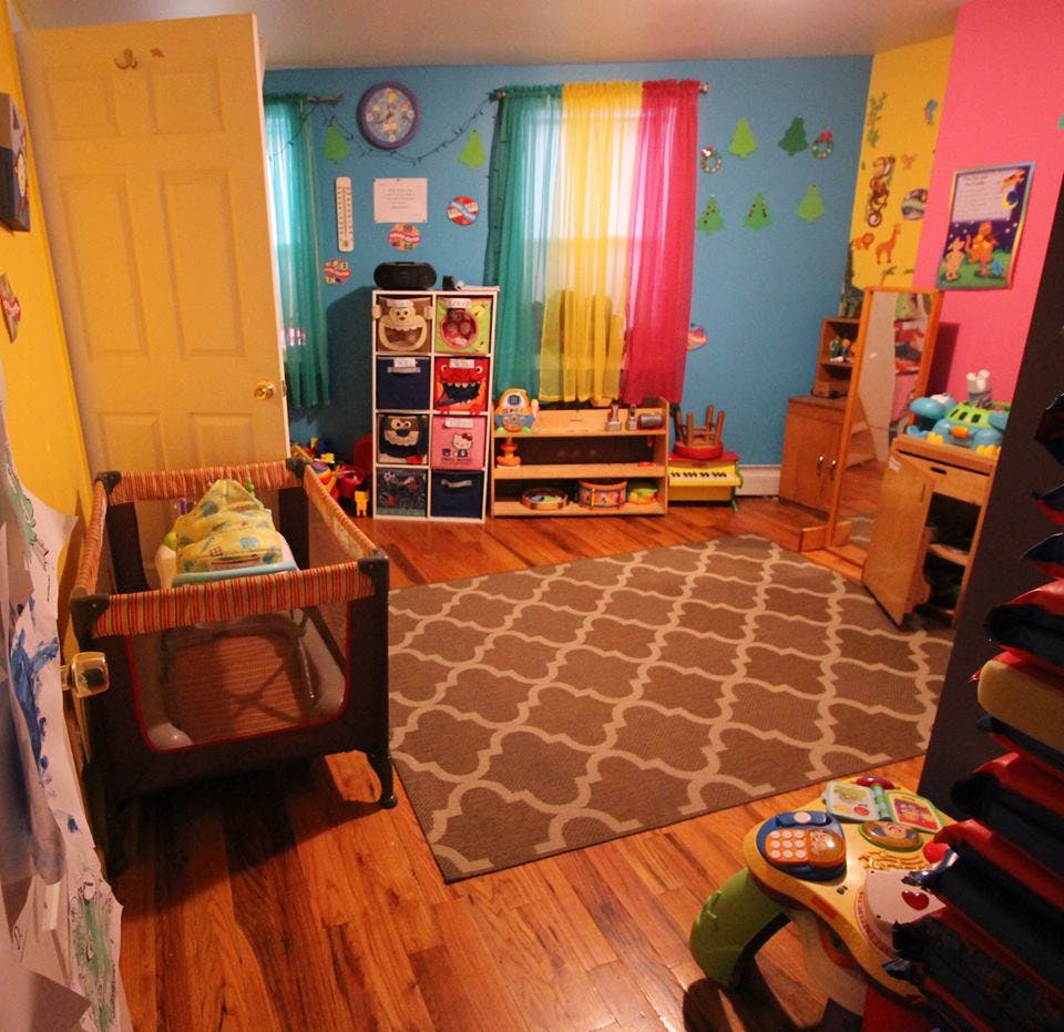 Child's room with a crib, rug, and colorful walls