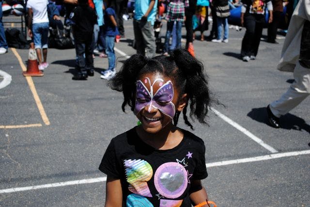 Child with purple butterfly face paint